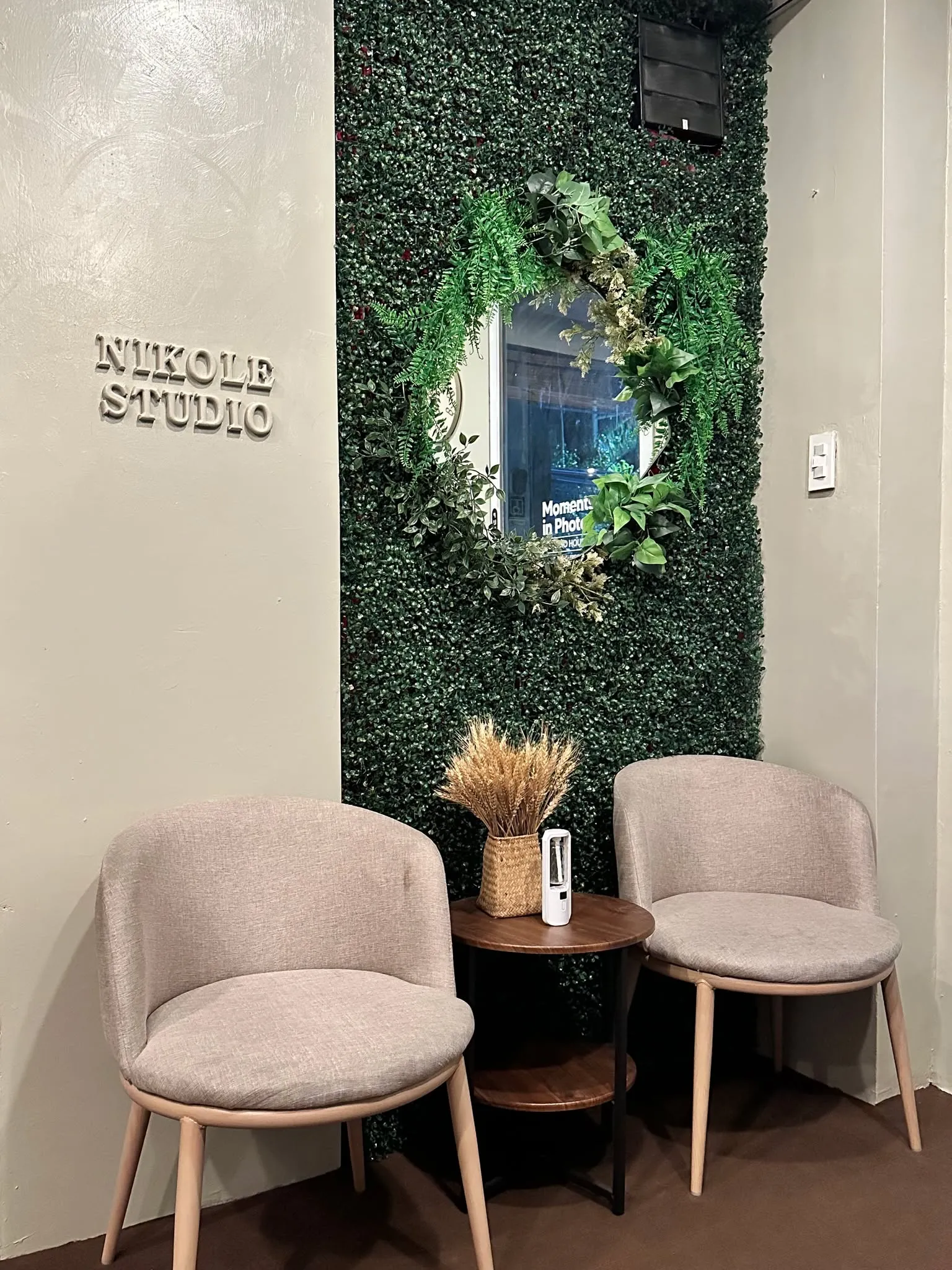 Client lounge with green wall and oval mirror
